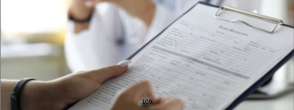 Person completing a form on a clipboard